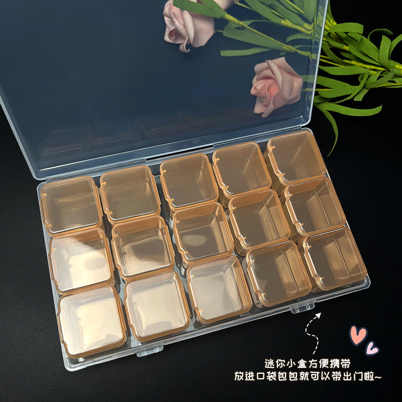 Transparent IBG jewelry storage box with multiple compartments for organizing necklaces, rings, and earrings.