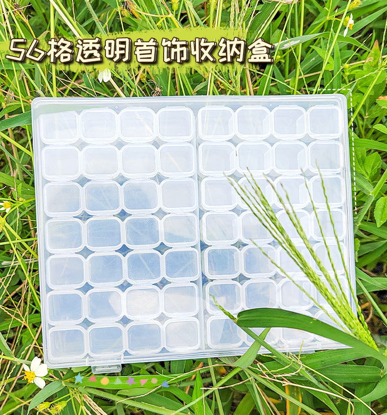 Transparent IBG jewelry storage box with multiple compartments for organizing rings, necklaces, and earrings.
