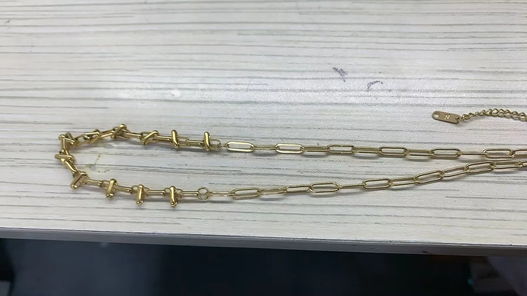 Stainless steel ball chain necklace from IBG, minimal everyday jewelry with small round links, suited for casual wear.
