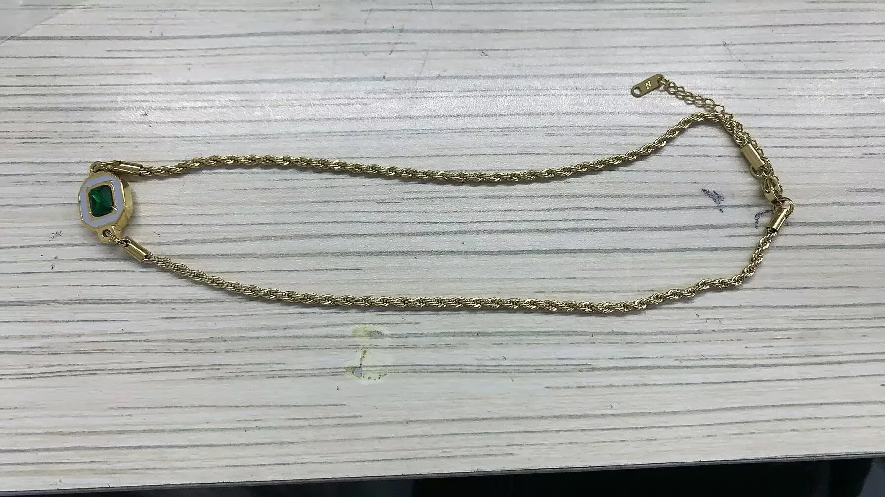 Stainless steel ball chain necklace by IBG, minimal everyday jewelry with shiny spherical links, on a white background.